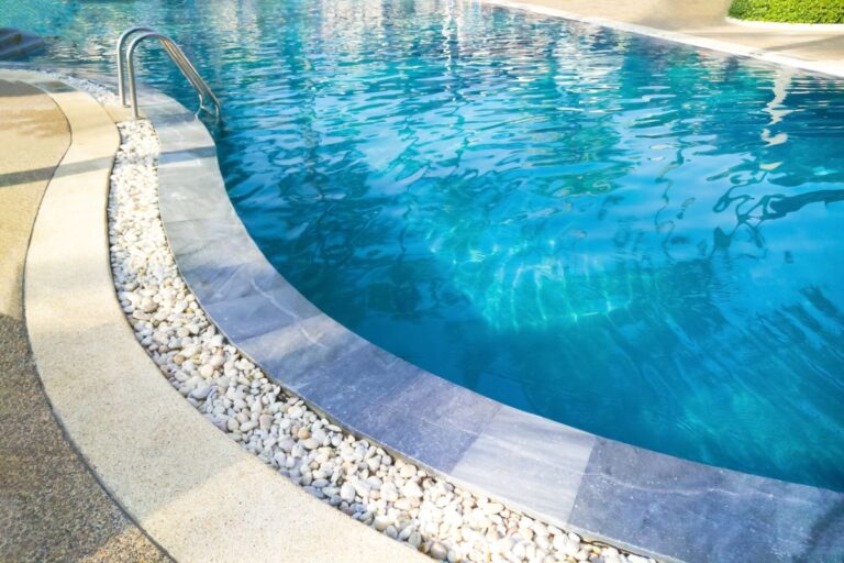 Swimming pool with metal ladder
